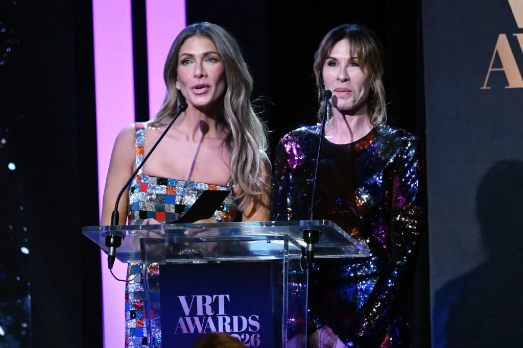 Erin Lichy and Carole Radziwill speaking at a podium during the Page Six Virtual Reali-Tea Awards.