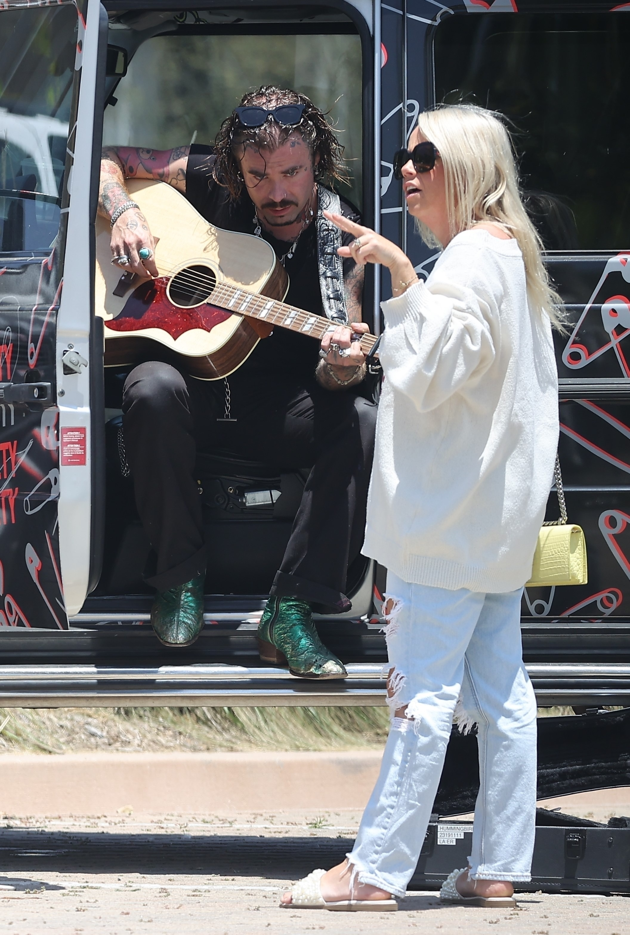 Mod Sun plays guitar for Sahara Ray while sitting in a customized vehicle.