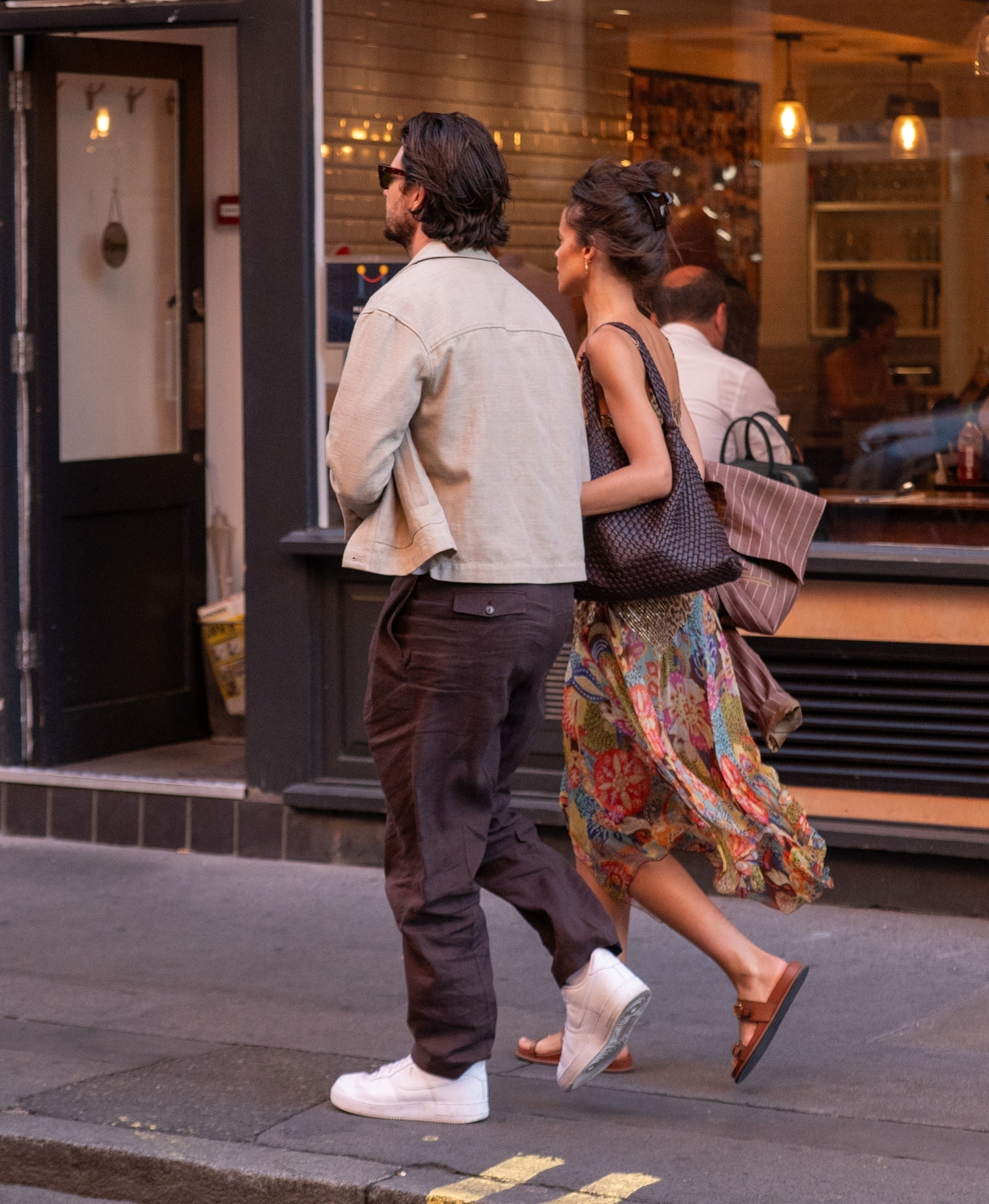 Ben Barnes and Aubrey Cleland walk arm in arm on a London street after a dinner date.