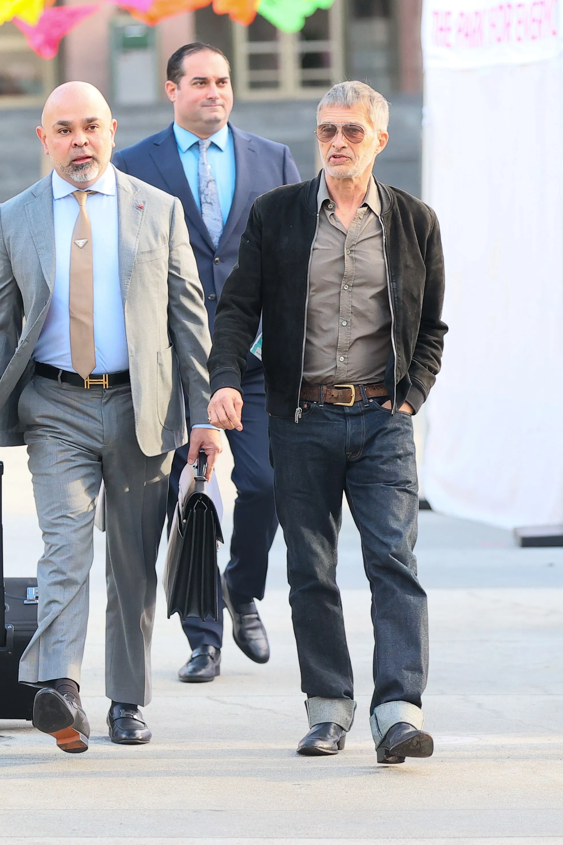 Olivier Martinez and security personnel arrive for a custody hearing.