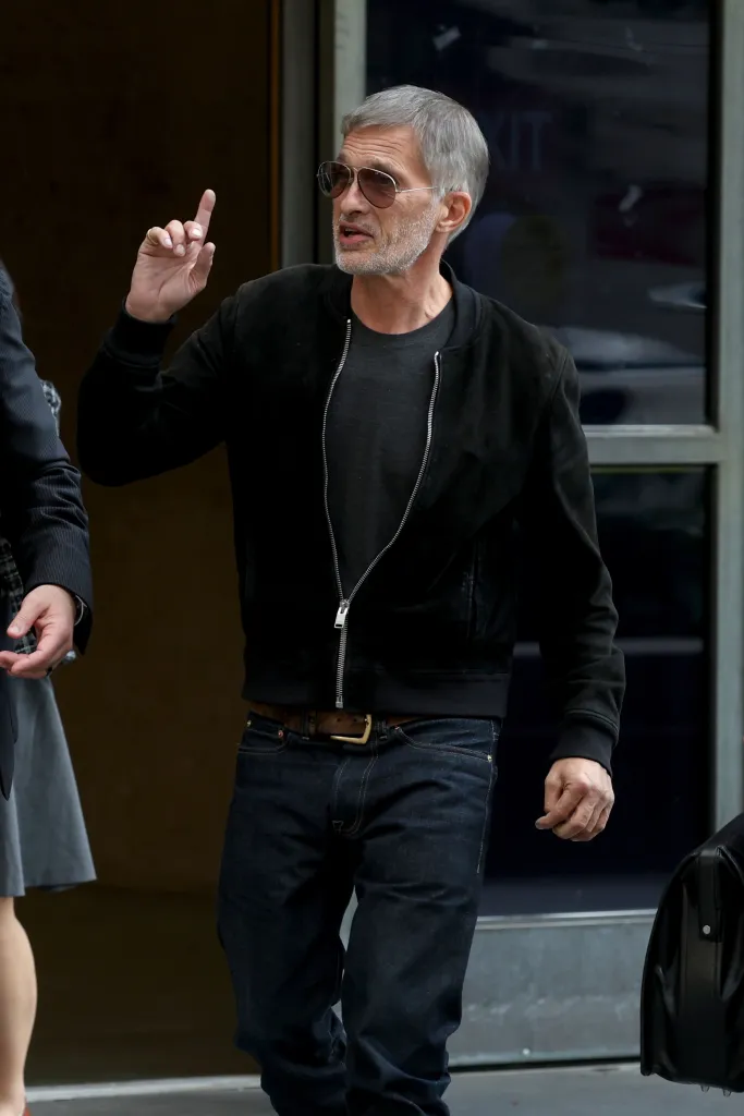 Olivier Martinez wearing sunglasses and a black jacket outside a courthouse in downtown Los Angeles.