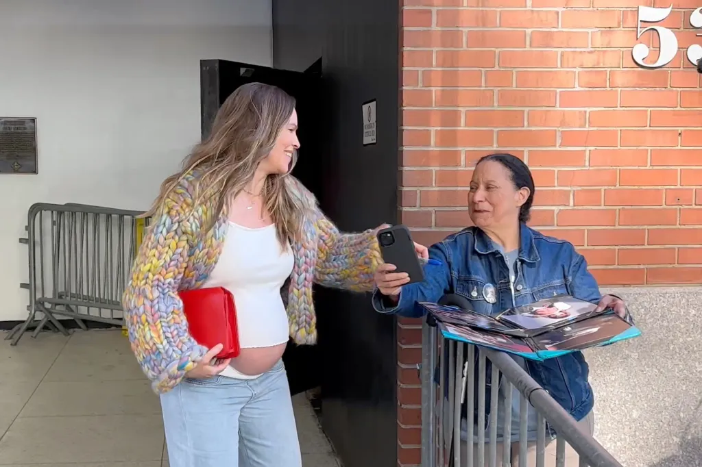 Hilary Swank greets a fan and signs an autograph in New York City.