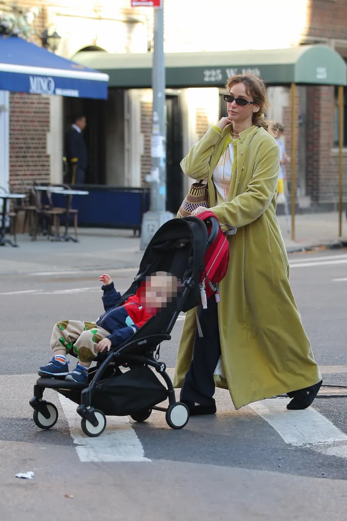 Jennifer Lawrence takes a stroll in New York with her child in a stroller.
