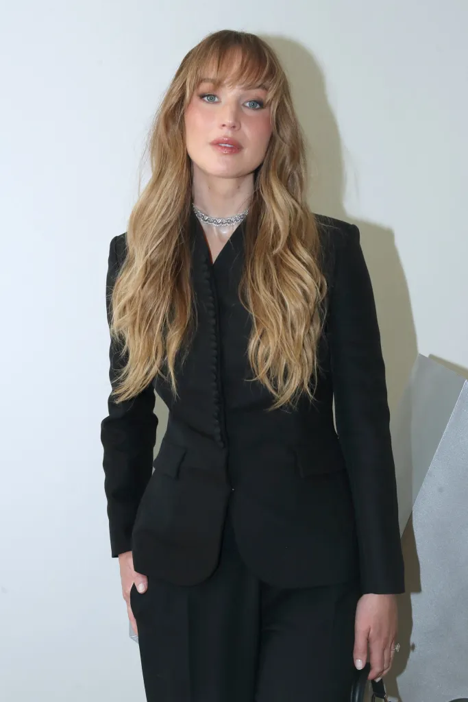 Jennifer Lawrence wearing a black suit and a diamond necklace at the LVMH Prize ceremony.