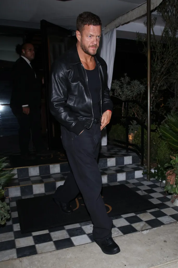 Dan Reynolds leaves The Bird Streets Club in West Hollywood wearing an all-black outfit consisting of a leather jacket, undershirt, and pants.
