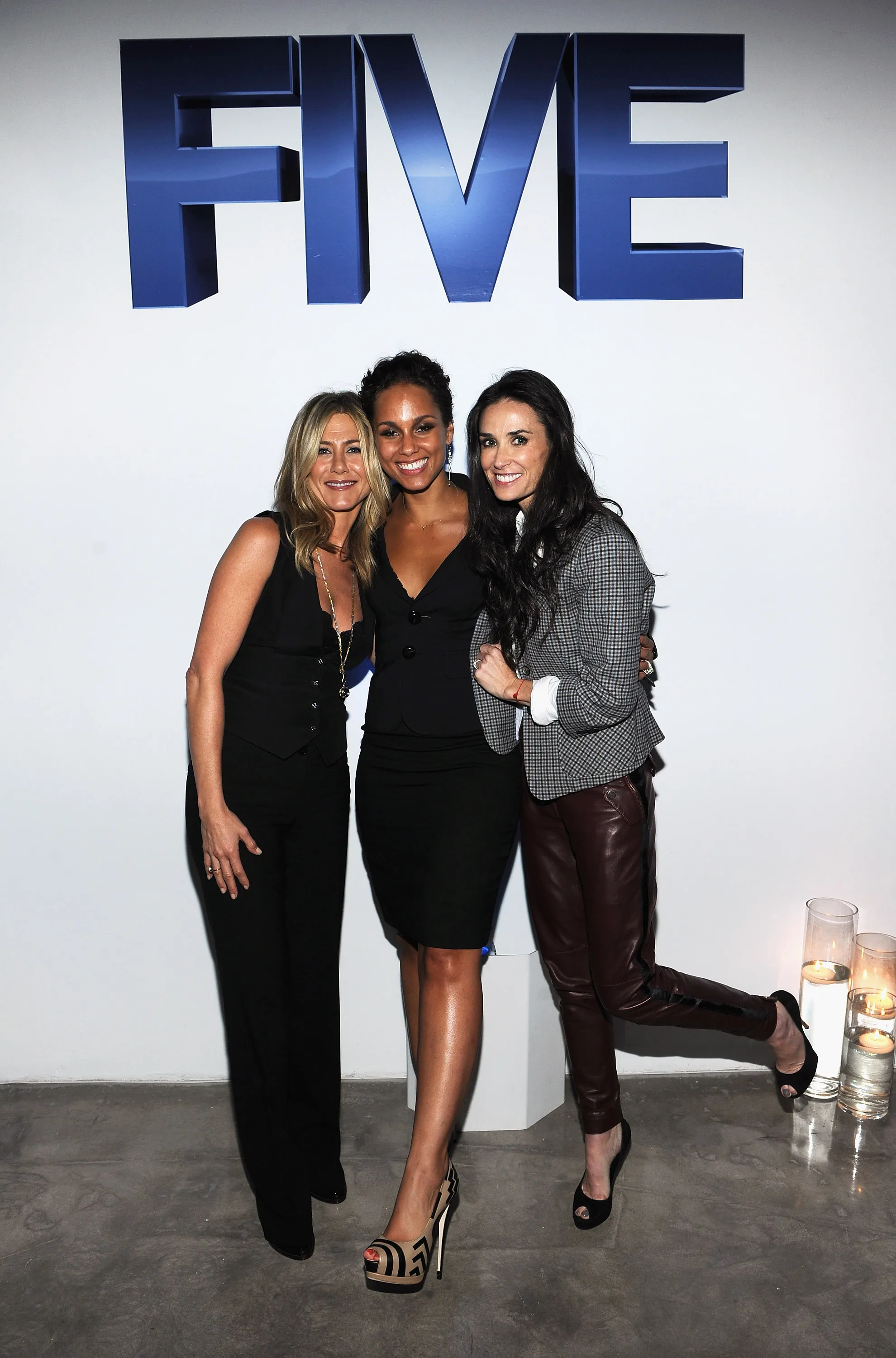 Jennifer Aniston, Alicia Keys, and Demi Moore pose together at the premiere of Lifetime's 