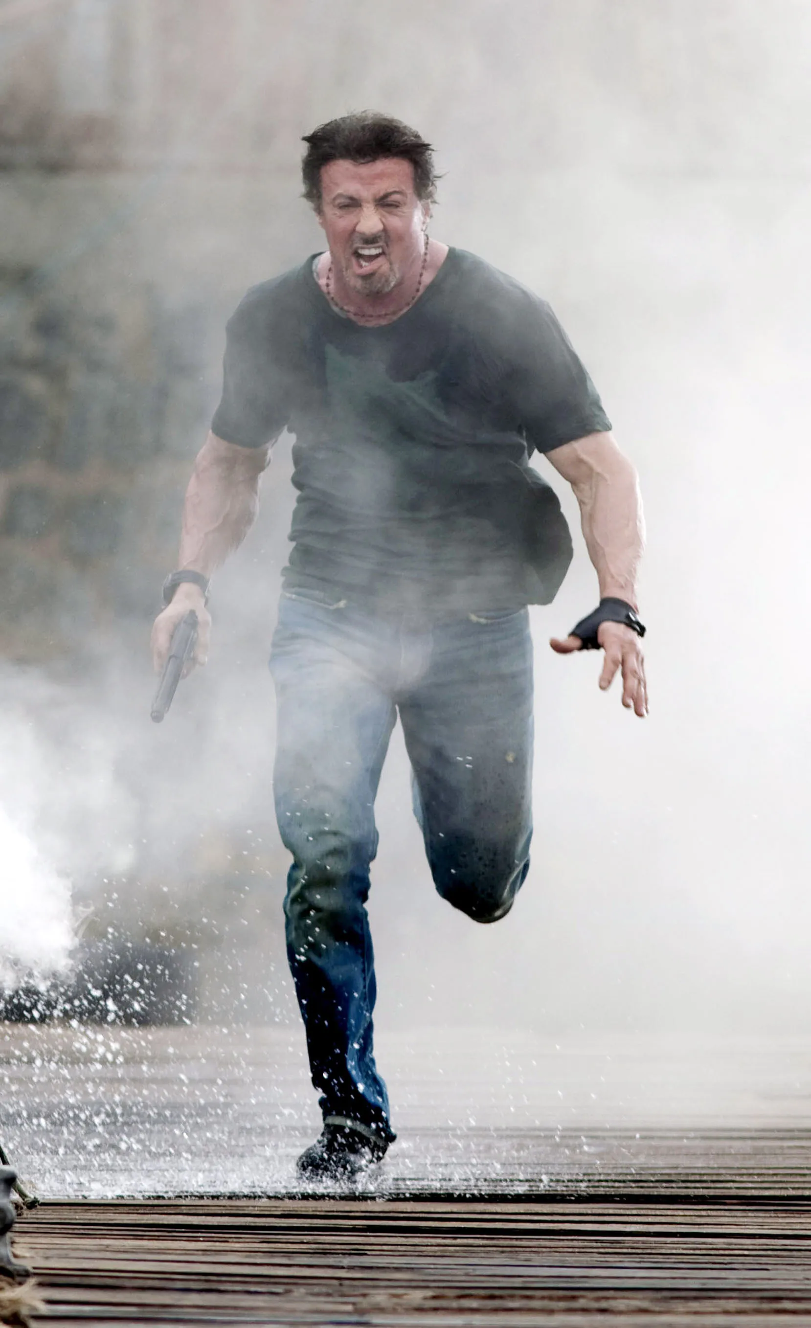Sylvester Stallone runs through smoke during a scene of the