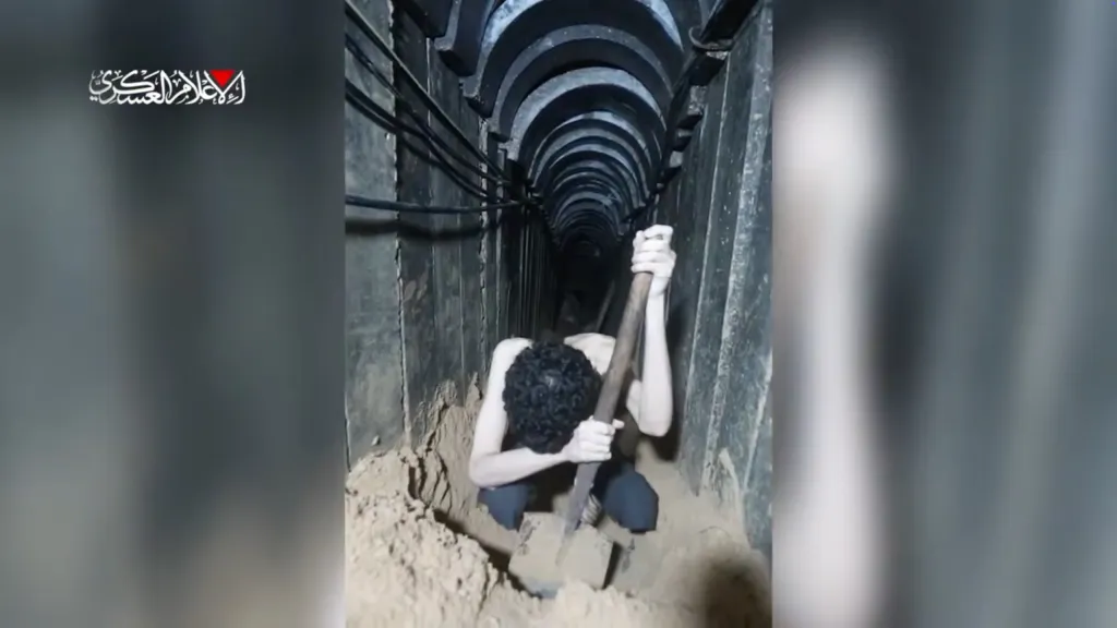Hostage Evyatar David digging in a tunnel with a shovel.