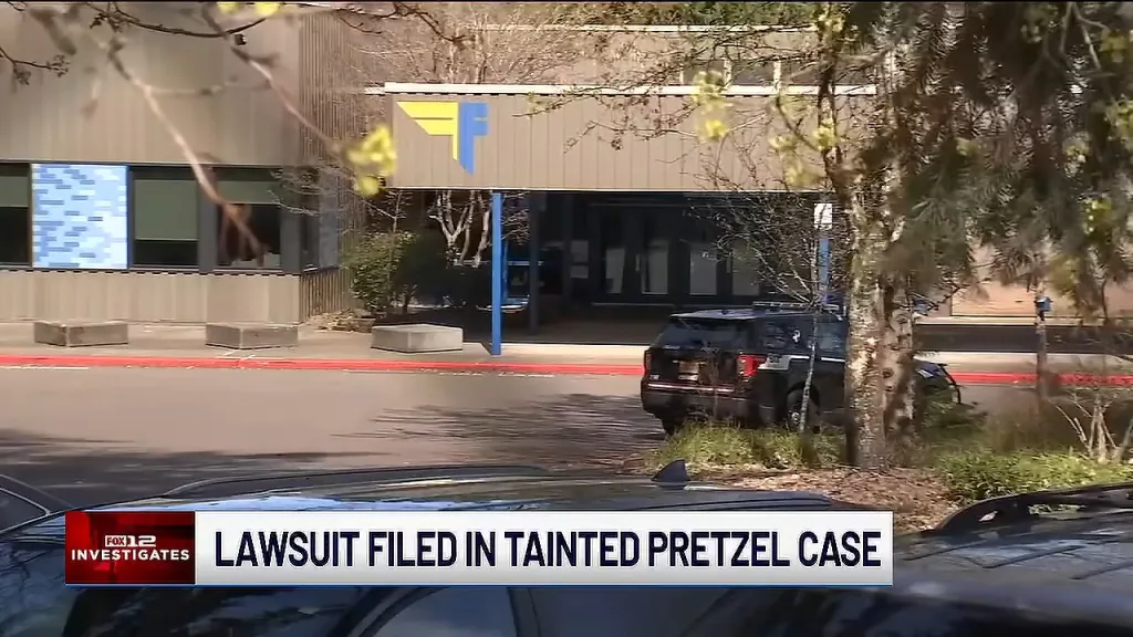 Exterior view of Fowler Middle School with a police vehicle parked outside, accompanied by a news graphic reading 