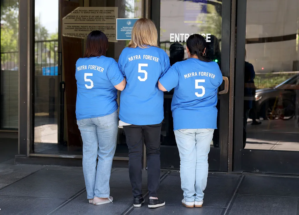 Family members wearing blue shirts that read 