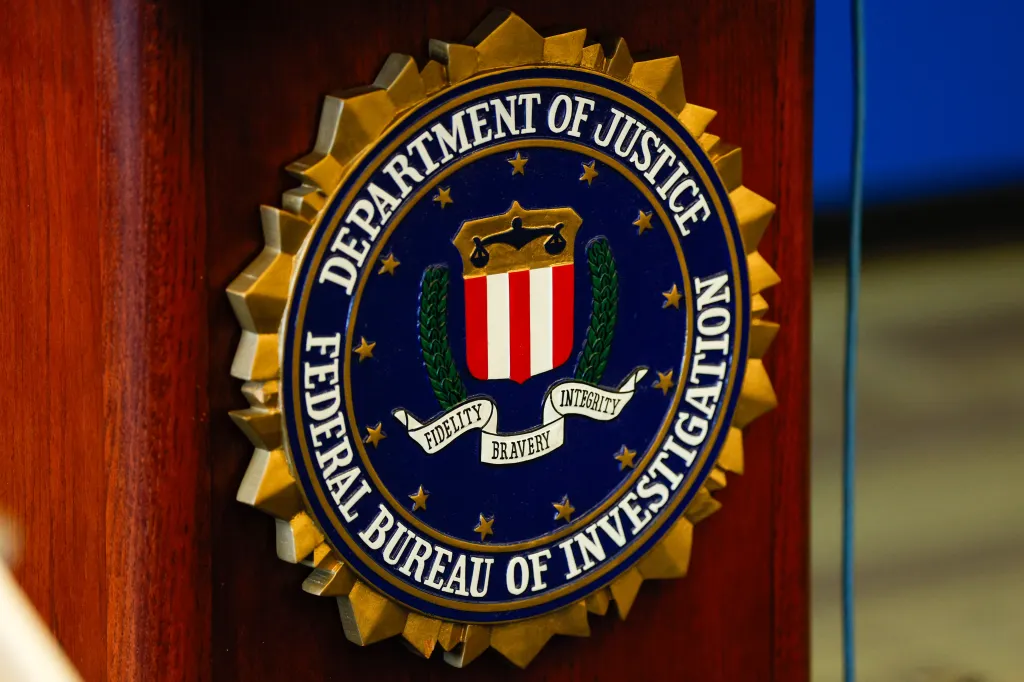 An FBI logo displayed on a podium during a press conference.