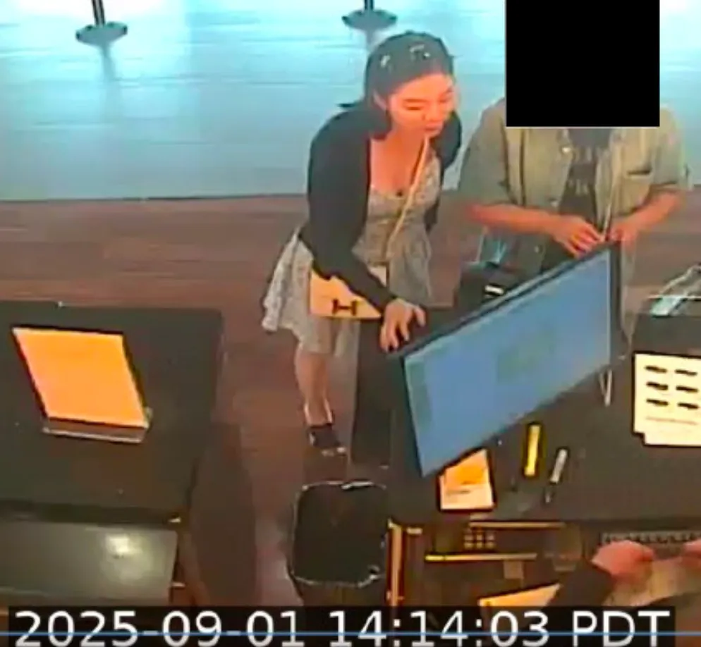 Surveillance image of Wanying Zhang standing at a counter.