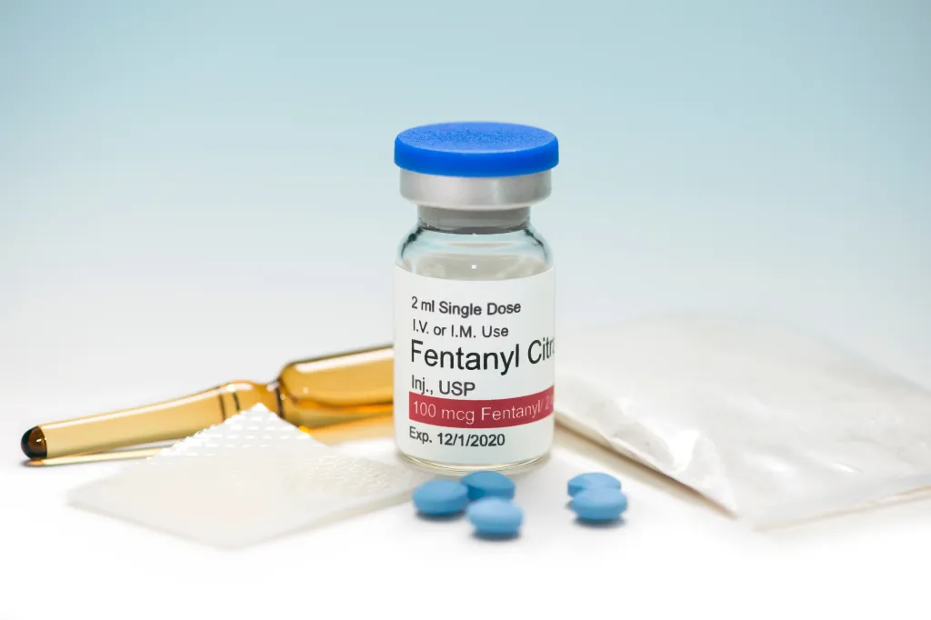 A Fentanyl Citrate vial with ampule, patch, powder, and pills.