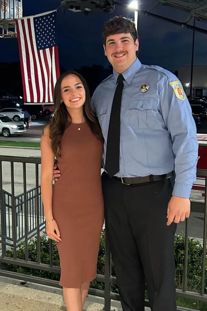 Firefighter Shane Hirstius poses with his fiancée, Leah Fonte, in front of an American flag.