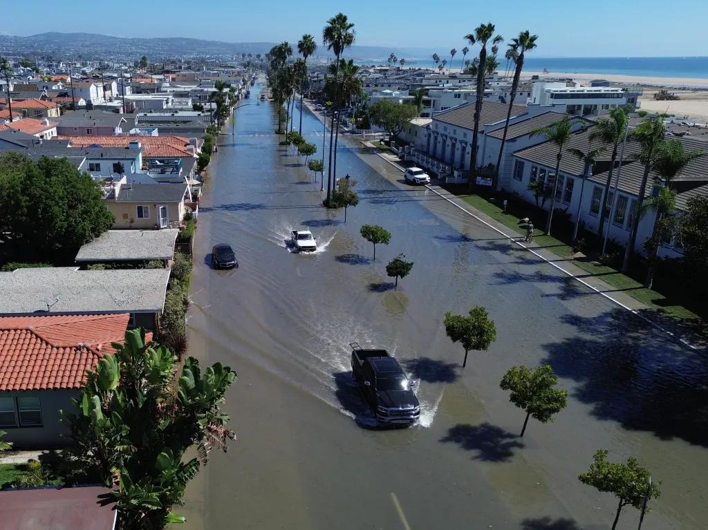 Floodwaters cover streets on the Balboa Peninsula in Newport Beach, California, as elevated tides and coastal conditions from Tropical Storm Rachel impact the area.