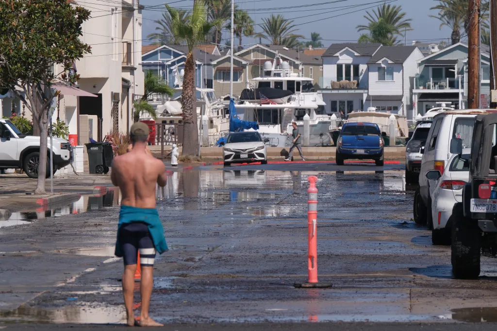Floodwaters cover streets on the Balboa Peninsula as elevated tides and coastal conditions cause flooding in Newport Beach.