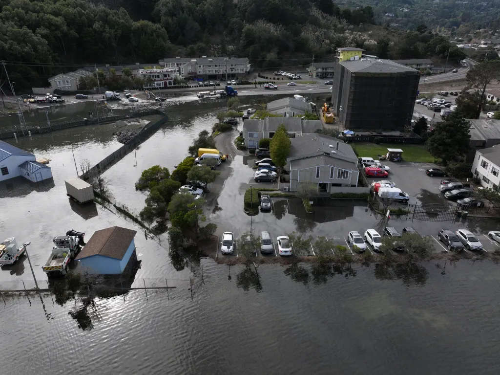 High tide and floodwaters covering roads and parking lots in Mill Valley, California.
