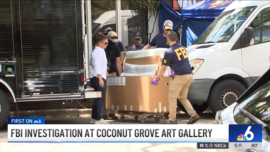 FBI agents loading artwork into a van outside an art gallery.