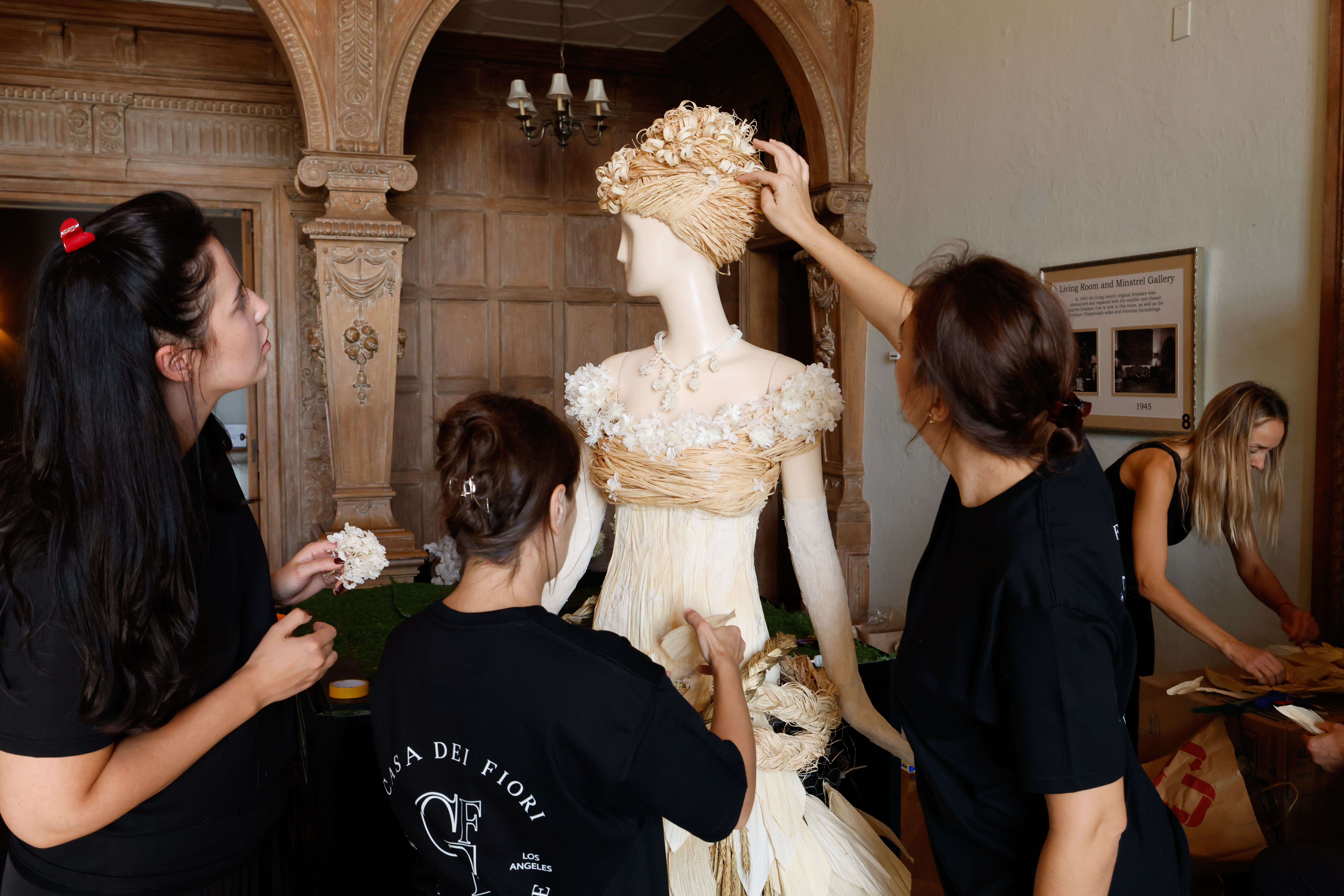 Florists work on an Ada Brook floral sculpture for 