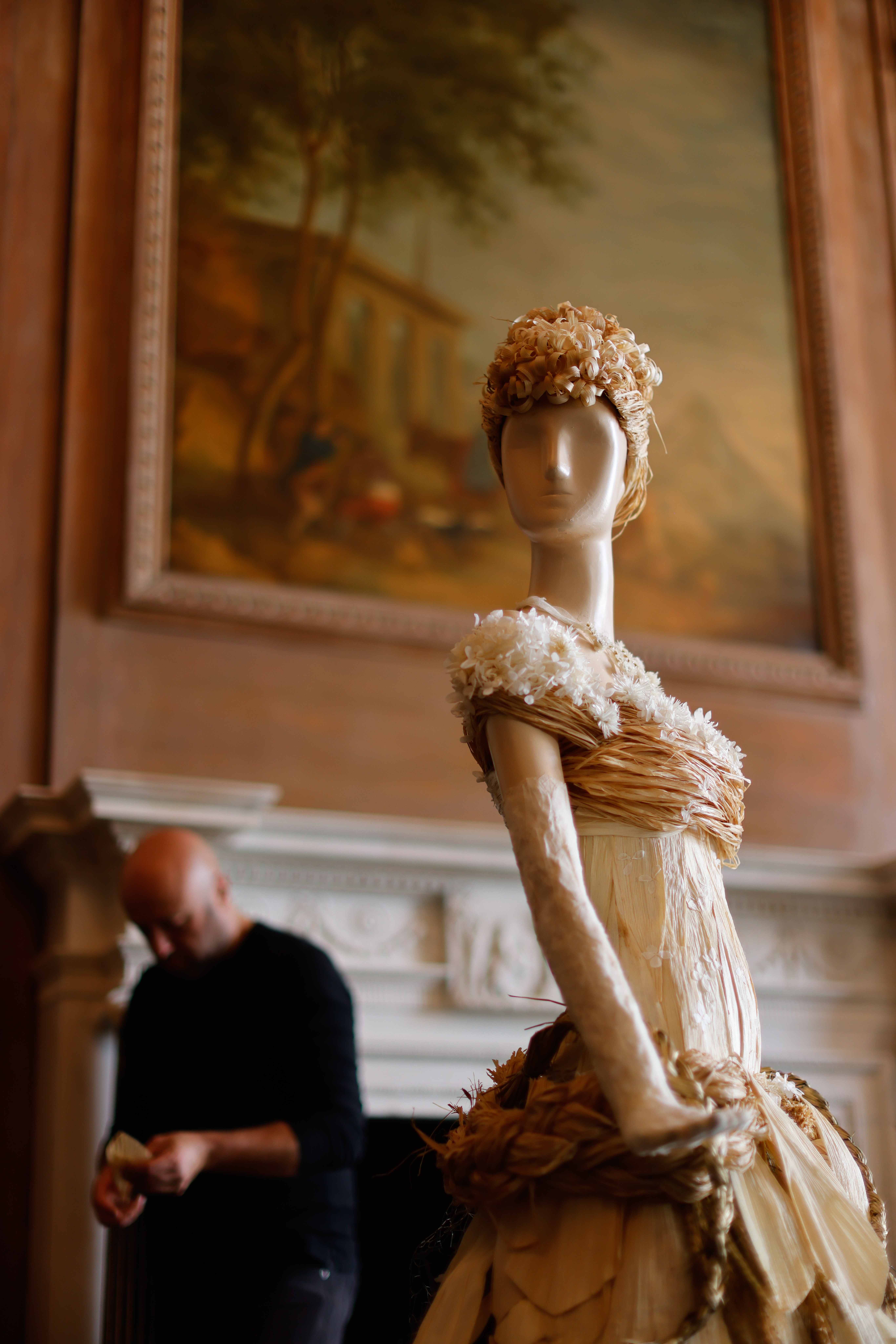 A florist works on an Ada Brooke floral sculpture for 