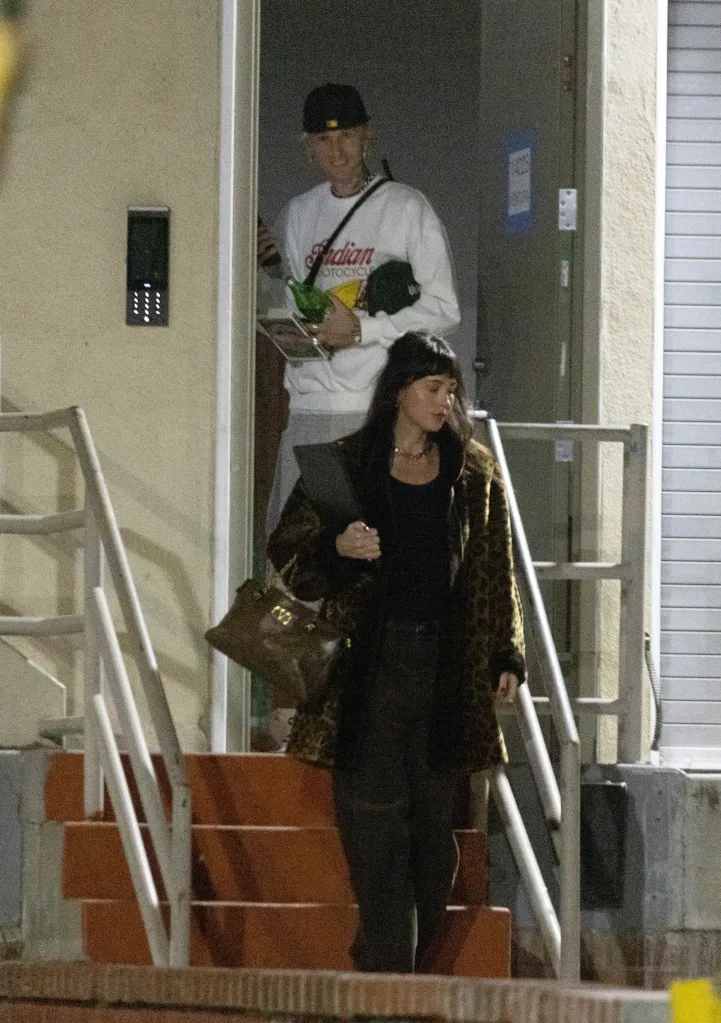 Dakota Johnson and Machine Gun Kelly leave a recording studio together.
