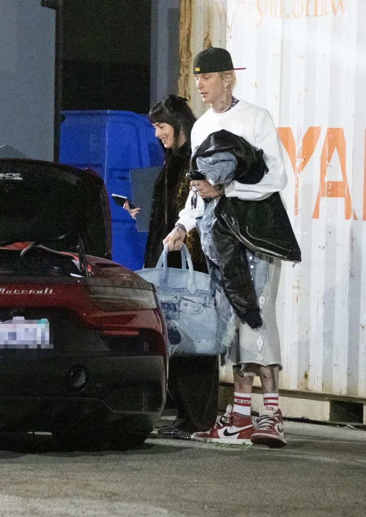 Dakota Johnson and Machine Gun Kelly are seen leaving a music studio together in Los Angeles, California.