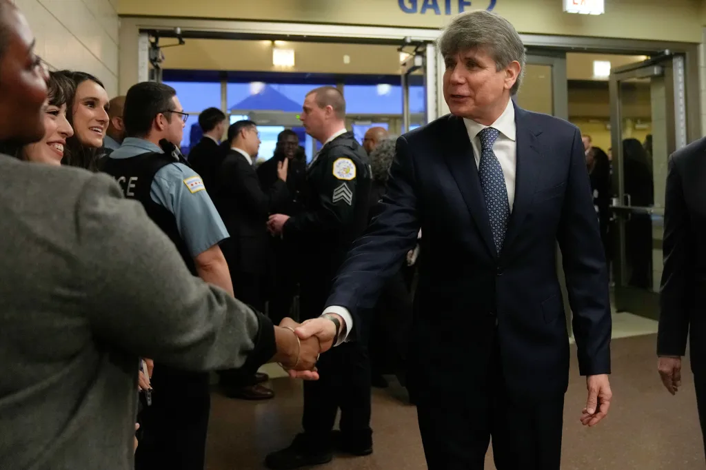 Former Illinois Governor Rod Blagojevich shakes hands with attendees at the House of Hope in Chicago.