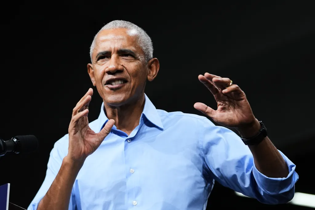 Former President Barack Obama speaking and gesturing to supporters.