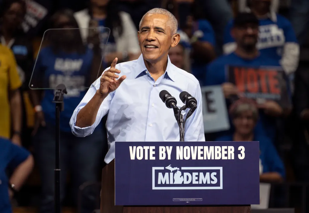 Former President Barack Obama speaks at a podium with a