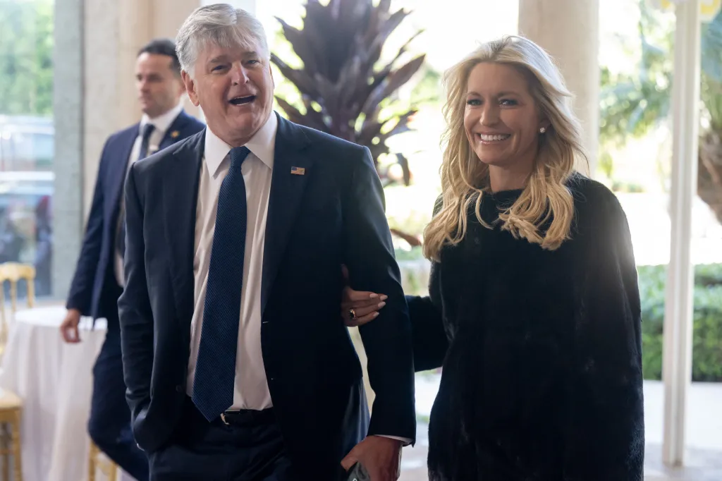 Fox News hosts Sean Hannity and Ainsley Earhardt walking together.