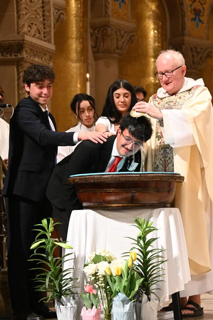Fr. Bart baptizing freshman Nick Mendez at the Easter vigil at Stanford Memorial Church.