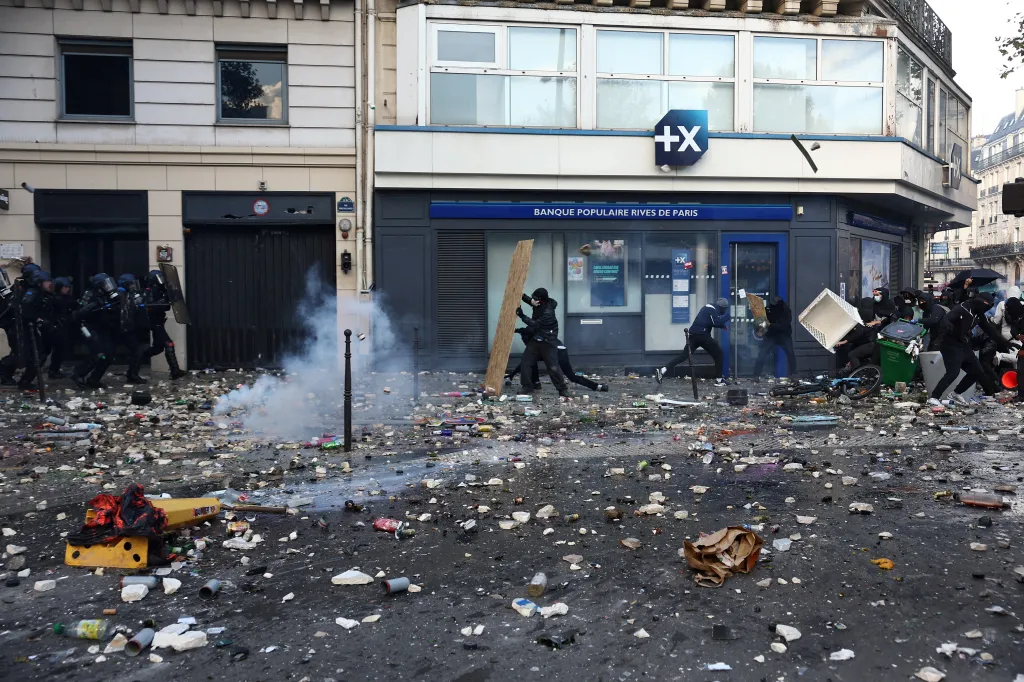French gendarmes face off with protesters during clashes at Place de la Republique in Paris.