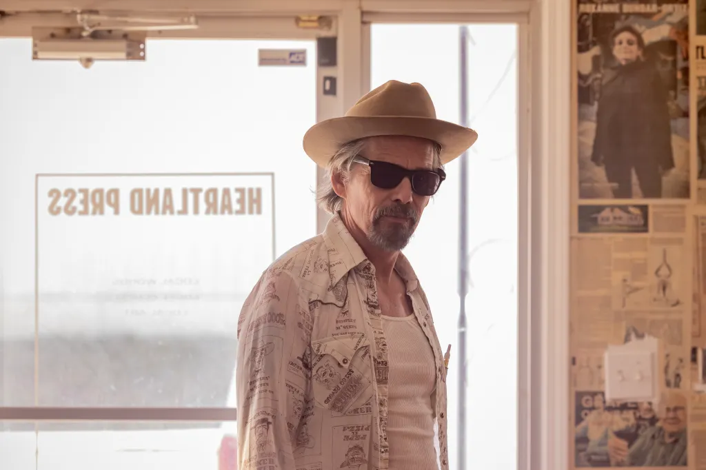 Ethan Hawke as Lee Raybon wearing sunglasses and a hat in The Lowdown.