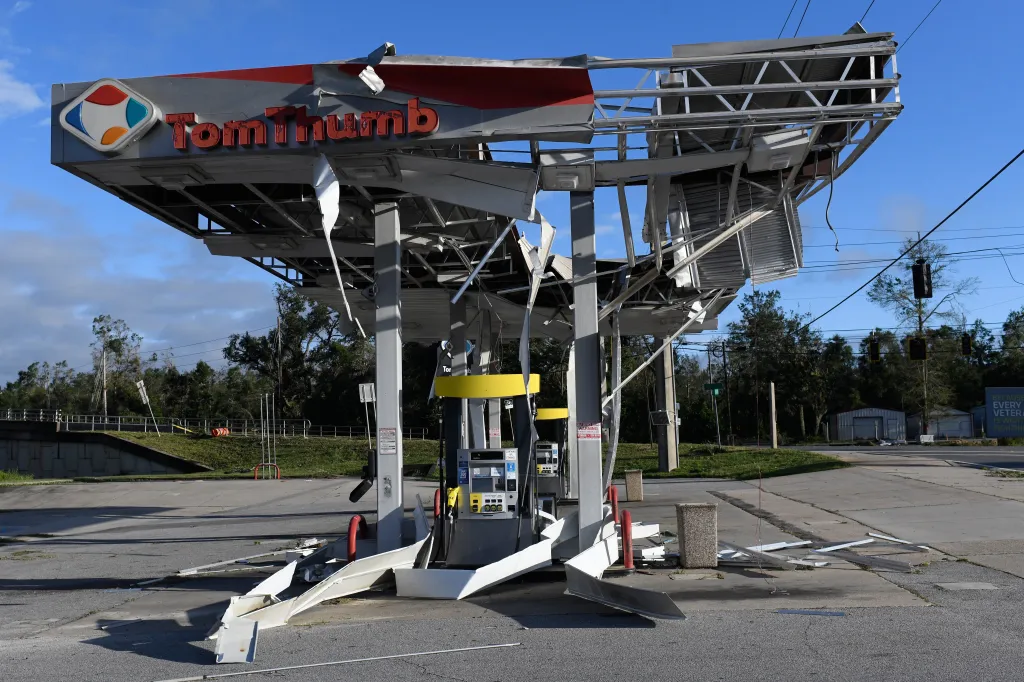 A gas station in East Milton, Florida, is severely damaged by the effects of Isaias, with its metal canopy collapsed and twisted.