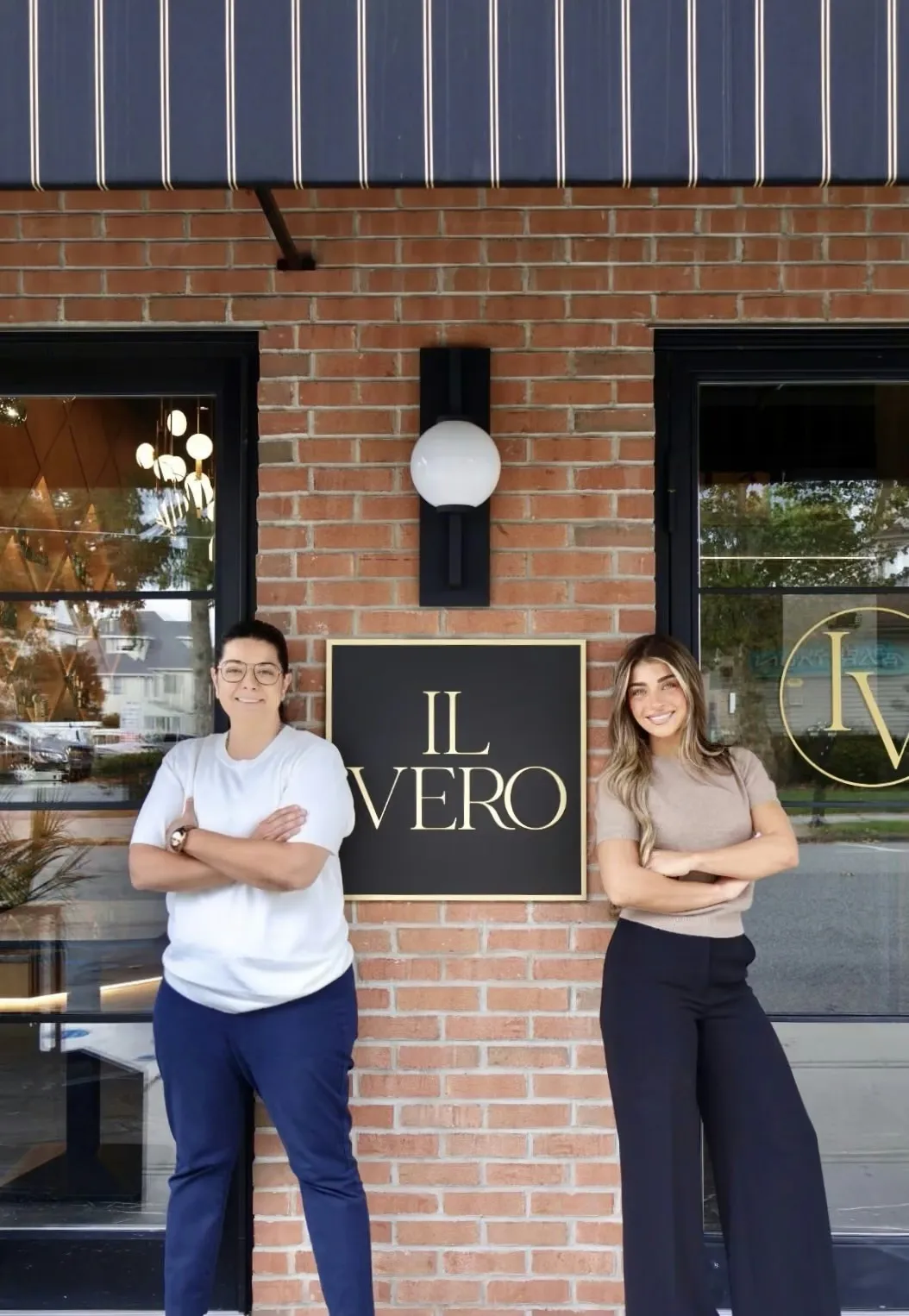 Maria Sausa and Gia Giudice posing outside their restaurant, Il Vero.
