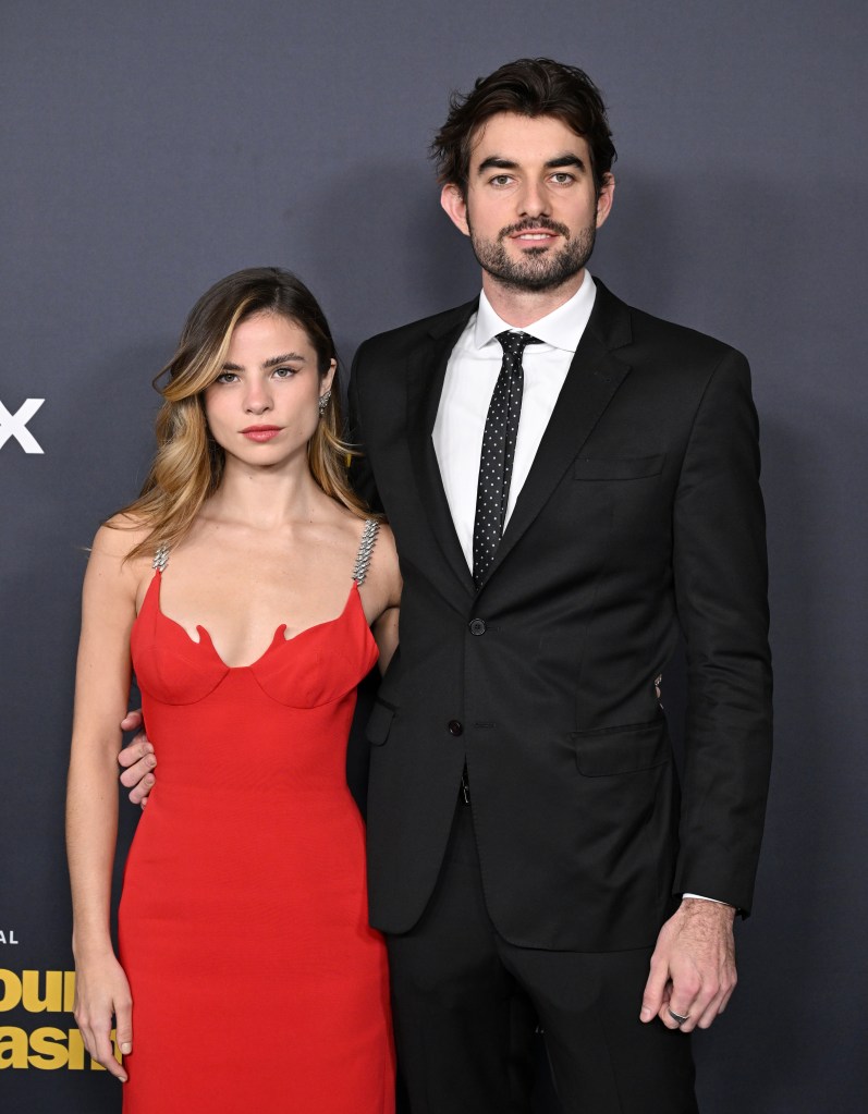 Giulia Be and Conor Kennedy posing together at a premiere.