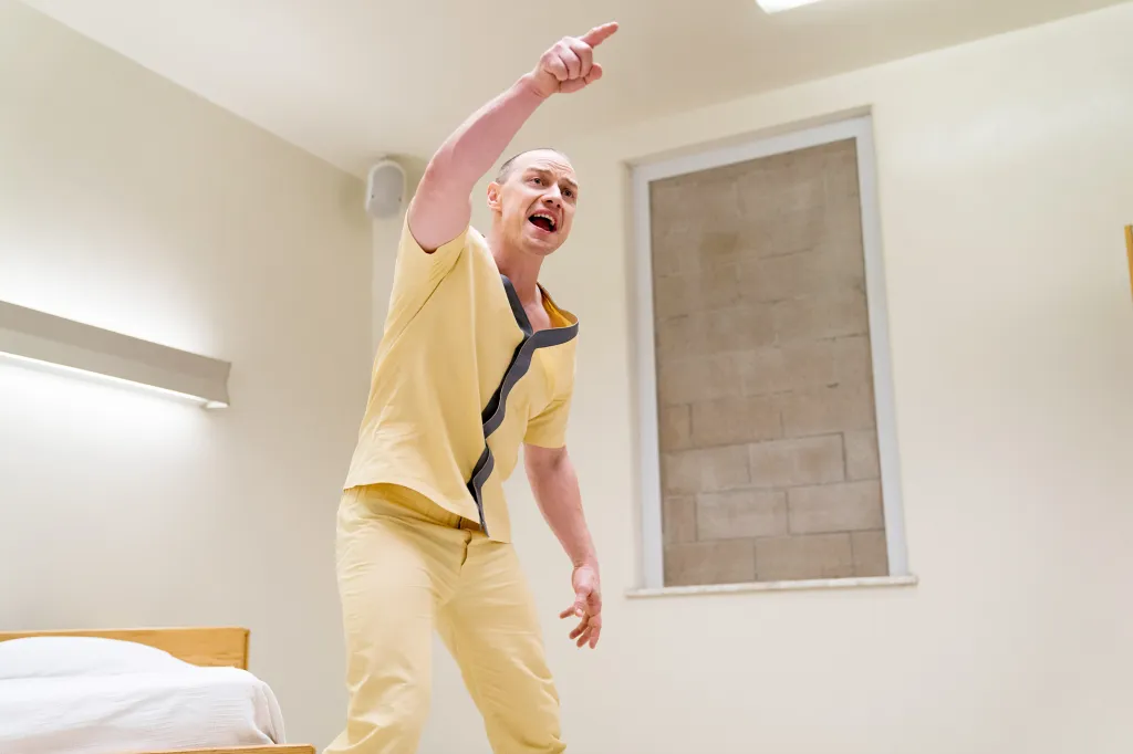 James McAvoy as Kevin Wendell Crumb in Glass, pointing and shouting in a hospital room.
