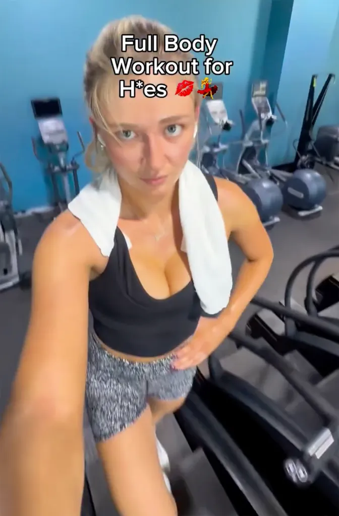 A woman in a black sports bra and grey patterned shorts works out on a stairclimber in a gym, with the text 