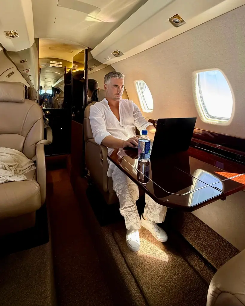 Gregg Starr working on a laptop while seated on a private jet.