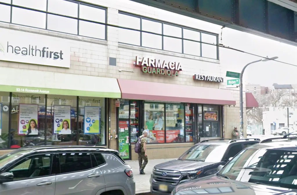 Exterior view of Guardiola Pharmacy INC on Roosevelt Avenue in Jackson Heights, New York.