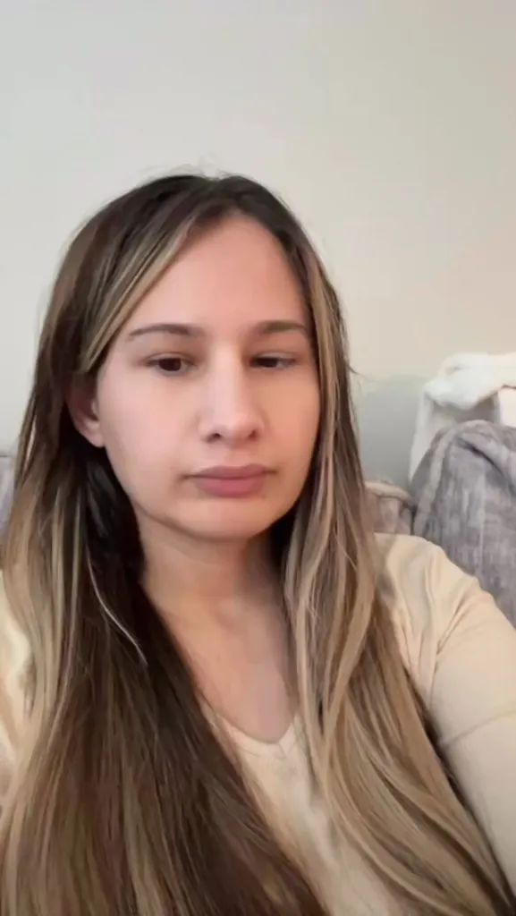 Gypsy Rose Blanchard with long blonde and brown hair, wearing a beige top.