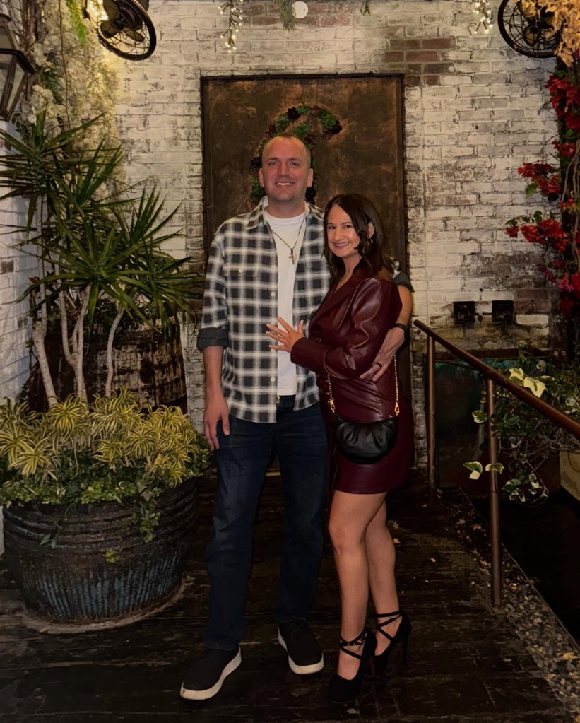 Gypsy-Rose Blanchard and Ken Urker pose together outdoors in front of a white brick wall and plants.