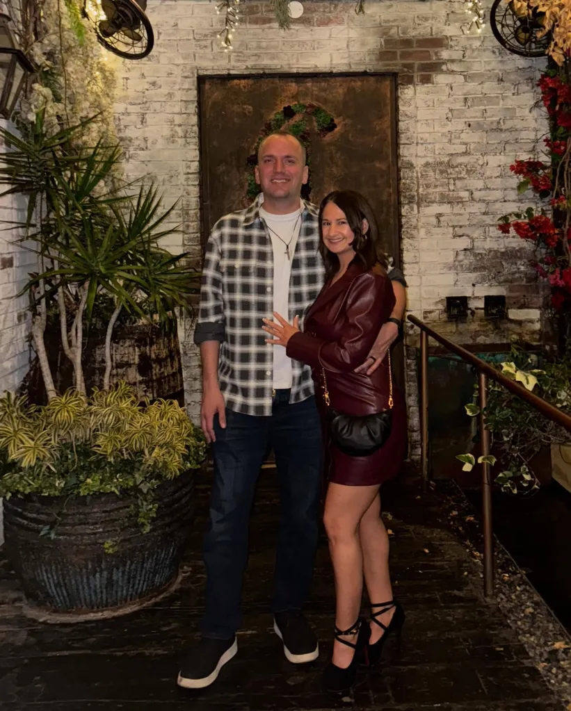 Gypsy-Rose Blanchard and Ken Urker pose together outdoors in front of a white brick wall.