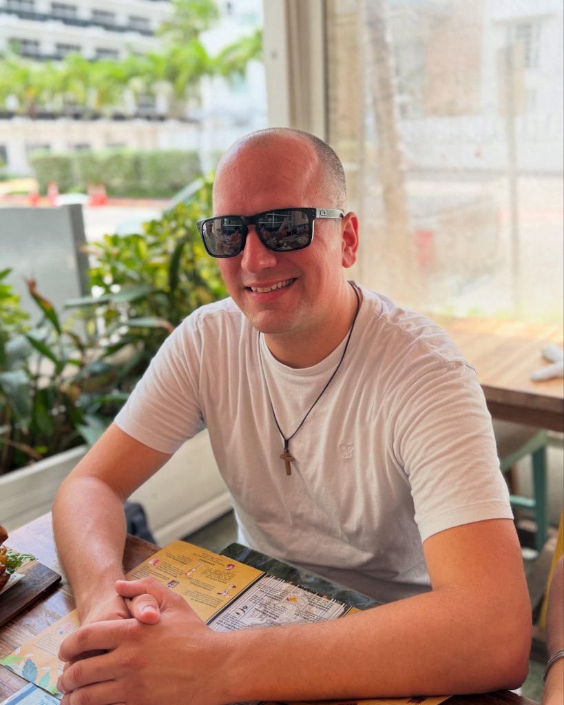 Ken Urker smiling at a restaurant table.
