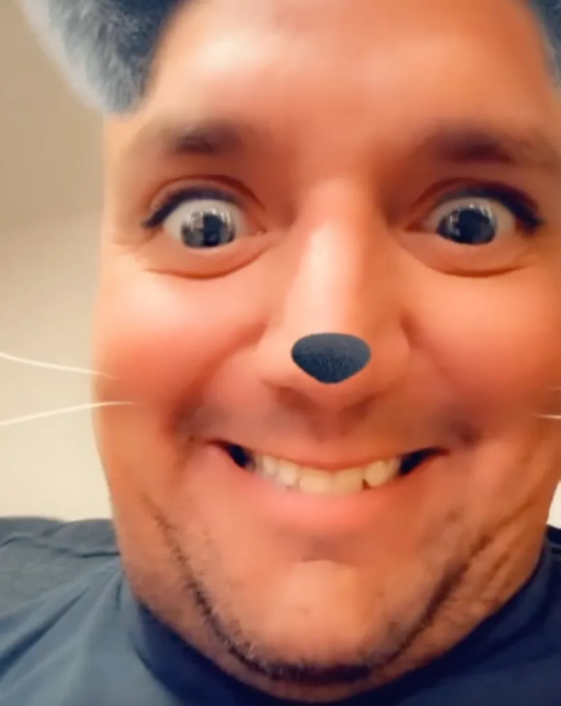 Close-up of Ken Urker using a social media filter with animal ears, a black nose, and whiskers.