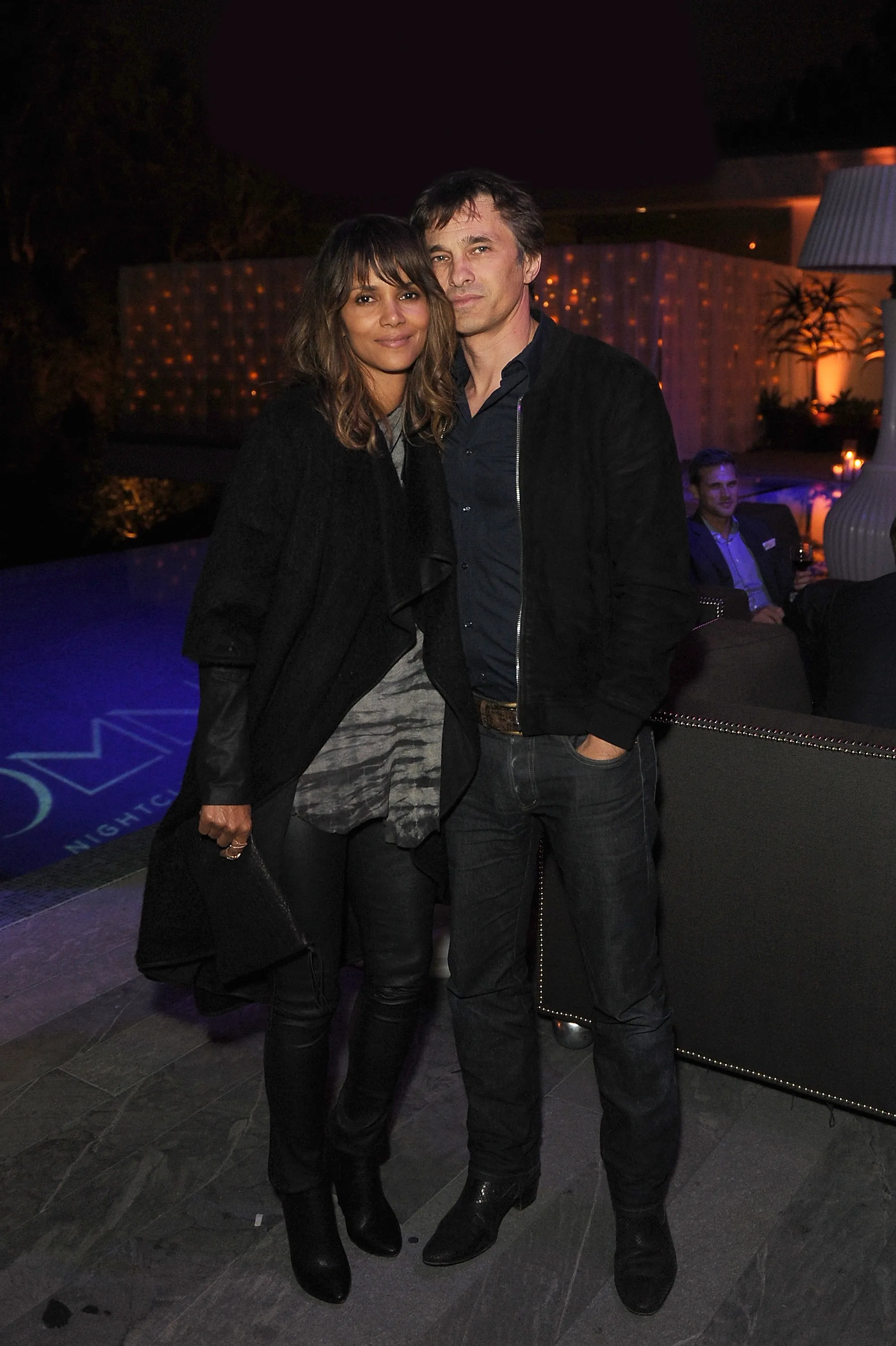 Halle Berry and Olivier Martinez posing together at an evening event.