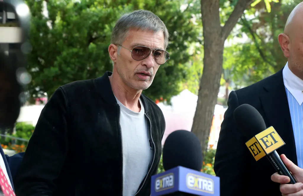 Olivier Martinez surrounded by microphones outside the Stanley Mosk Courthouse in Los Angeles.