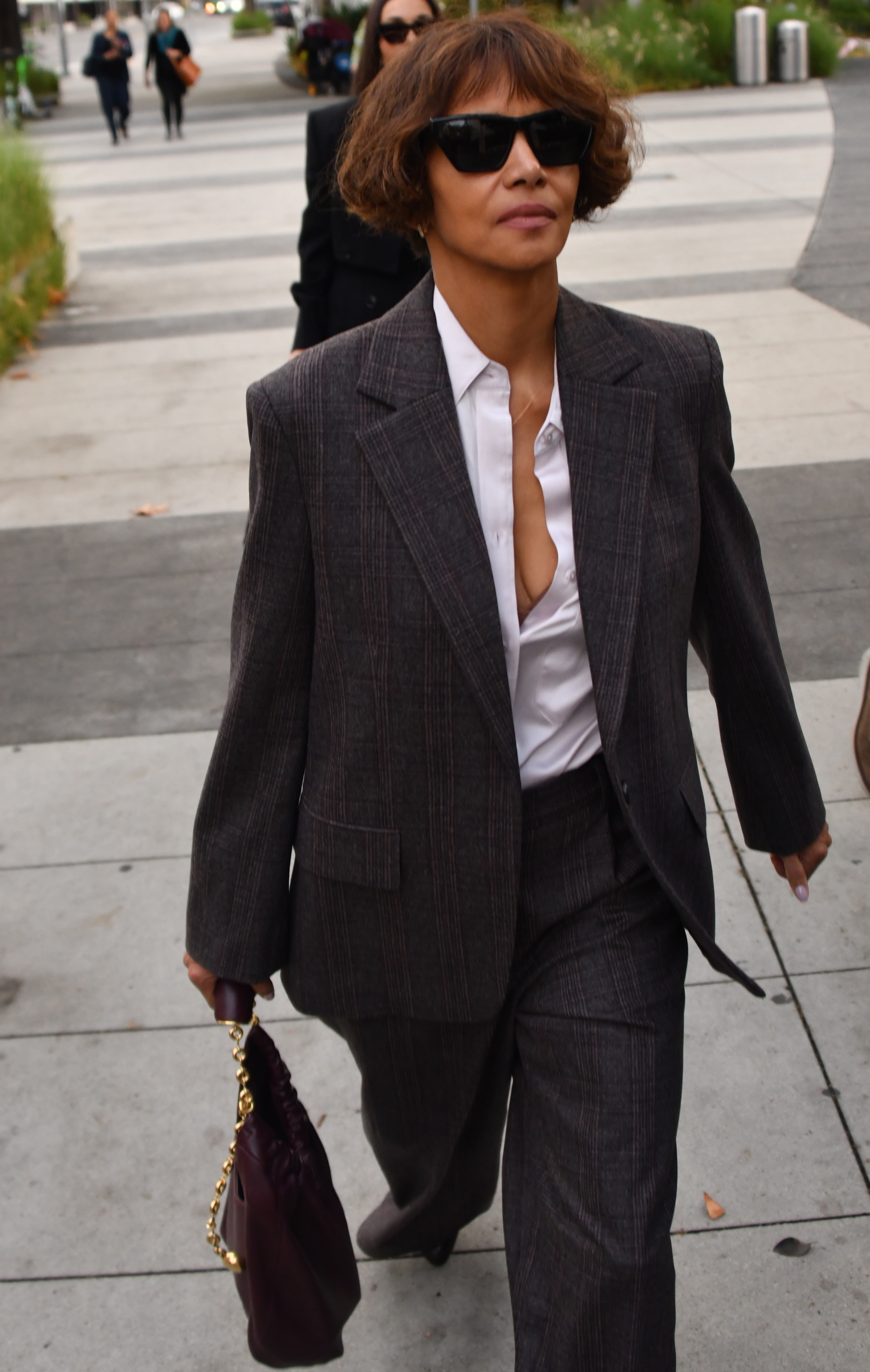 Halle Berry wearing a gray plaid pantsuit and sunglasses arriving at the Stanley Mosk courthouse.