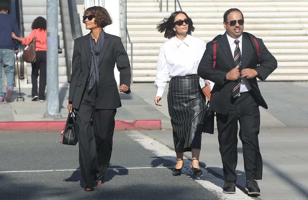 Halle Berry walking outside the Stanley Mosk Courthouse in Los Angeles, accompanied by two individuals.
