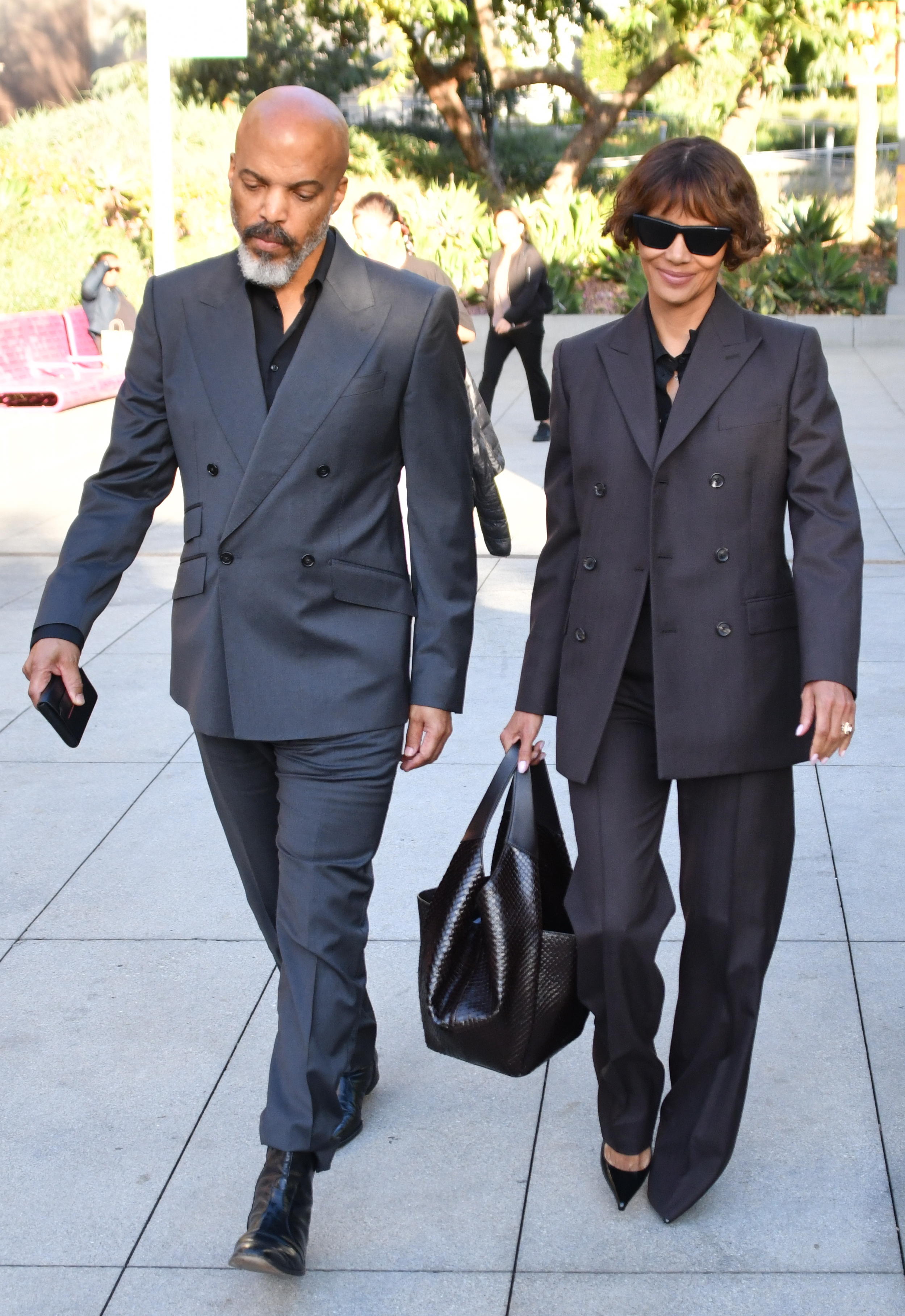 Halle Berry and Van Hunt walking outside together.